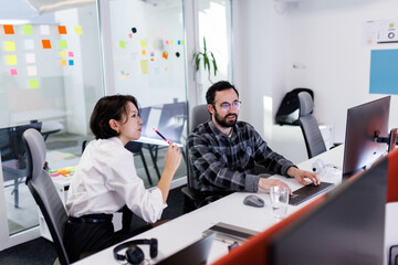 Fototapeta premium Business professionals collaborate in a modern office space, focusing on tasks while utilizing technology during a productive work session