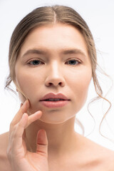 Obraz premium Captivating young woman gently touching her face in a serene moment of self reflection