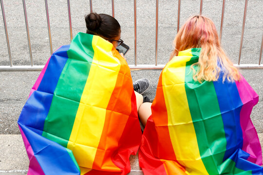 New York City, NY  USA  Pride March 2017 Couple wrapped in rainbow pride flags LGBTQ lifestyle moment Editorial ONLY
