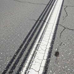 Fototapeta premium Abstract Tire Tracks Mark Cracked Asphalt Surface