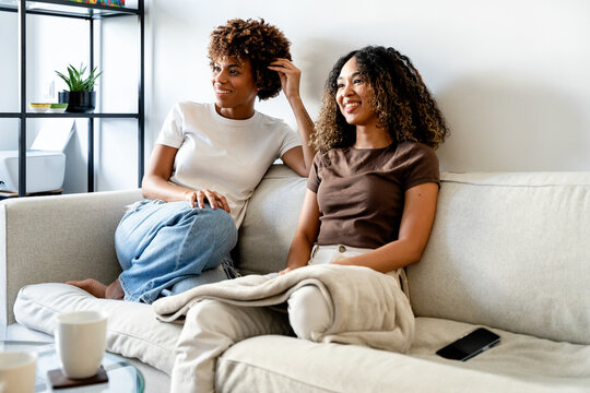 Friends enjoying relaxed time on a cozy home sofa