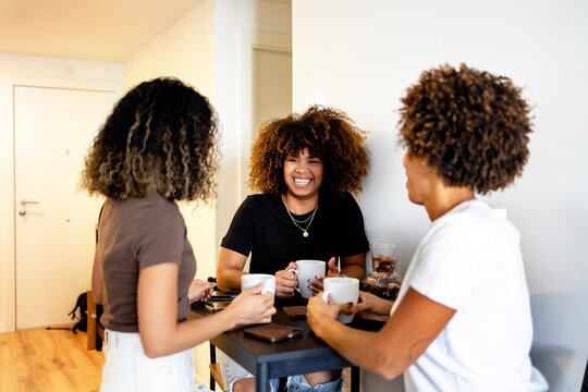 Friends enjoying coffee while sharing laughs