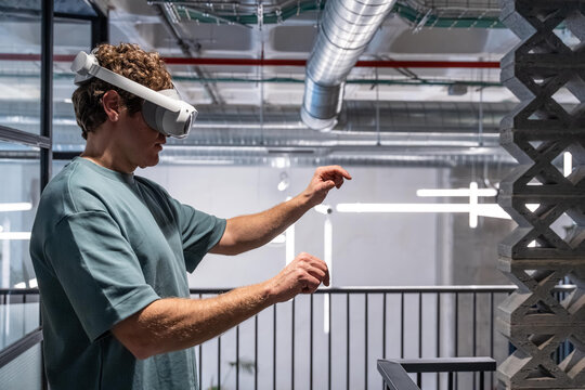 Man interacting with virtual reality headset indoors