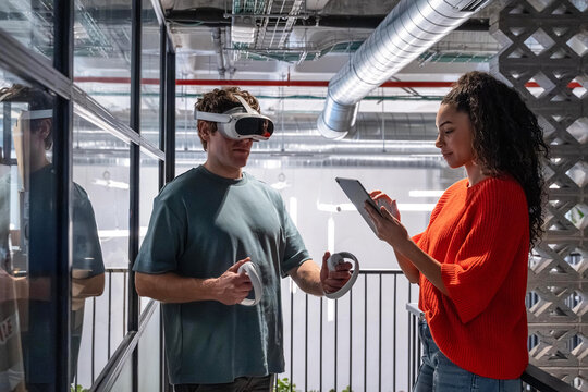 Multiethnic team using VR in modern office space