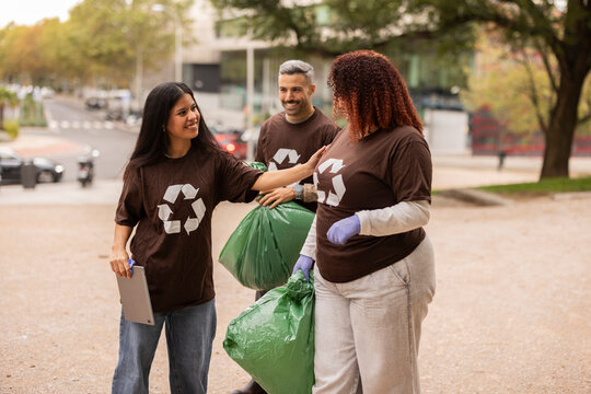 Multiethnic friends volunteering in park cleanup