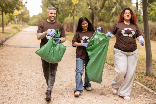 Multiethnic group cleaning park for eco initiative