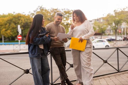Multiethnic friends sharing ideas in the city