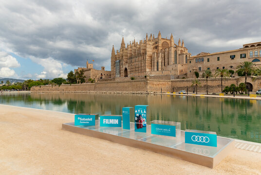 Palma, Mallorca, Spain - July 30, 2025: A picture of the Palma Cathedral and adverts on the Atlantida Mallorca Film Fest 2025.
