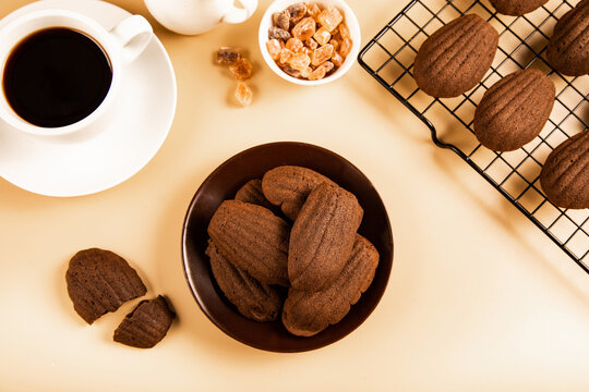 Coffee with chocolate madeleines on a table