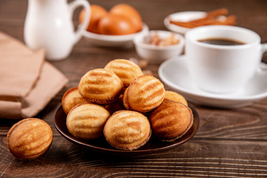 Delicious oreshki cookies with coffee on wooden table