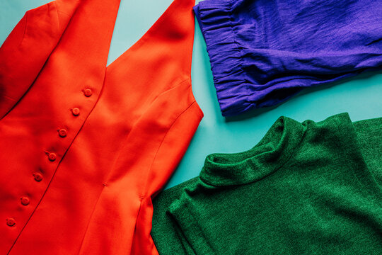 Vibrant display of colorful clothing on blue background