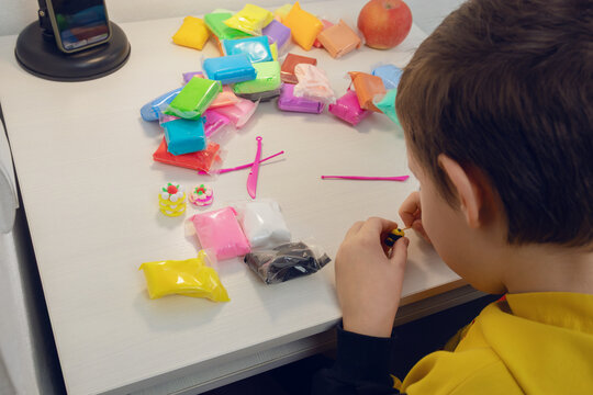 Child engaging in creative modeling clay art activity