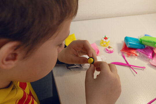 Child playing with colorful modeling clay