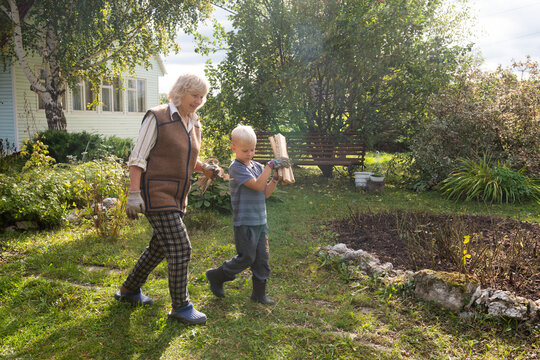 Grandmother and child gathering firewood together