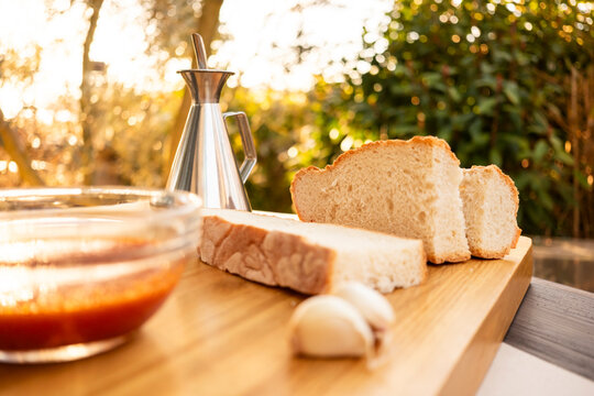 Rustic bread with oil, tomato, and garlic on wooden board