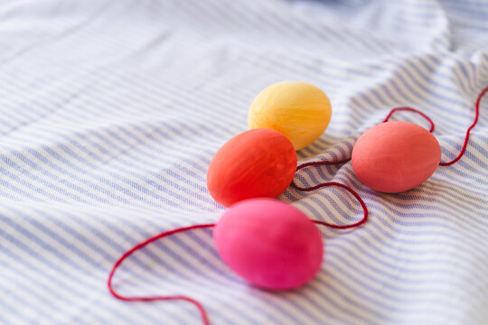Multicolored Easter eggs on striped fabric background