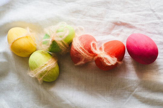 Multicolored Easter eggs with yarn decorations