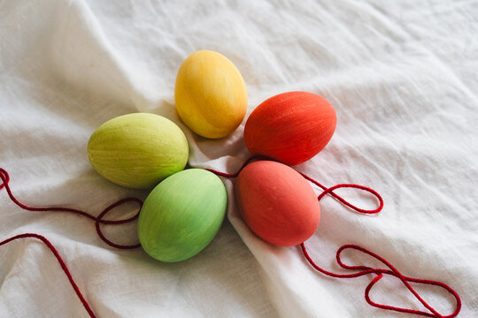 Multicolored Easter eggs on white fabric