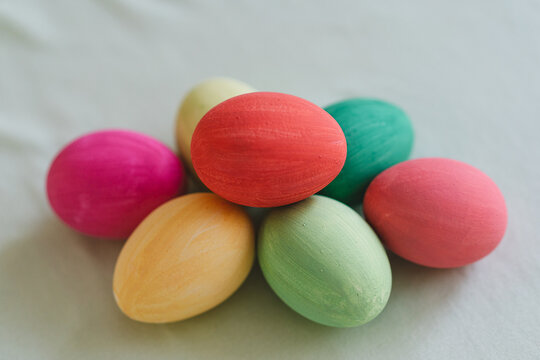 Colorful Easter eggs arranged on a soft fabric surface