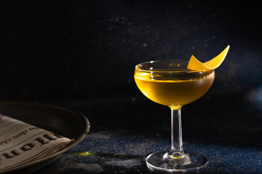 Elegant cocktail with citrus garnish in low light