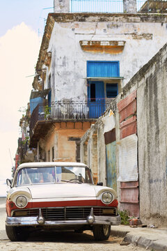 Vintage car on street in La Habana, Cuba with old buildings