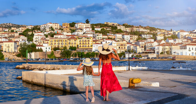 A mother and her daughter on summer vacations looking at the town of Pylos, Messinia, Peloponnese, Greece, during sunset time