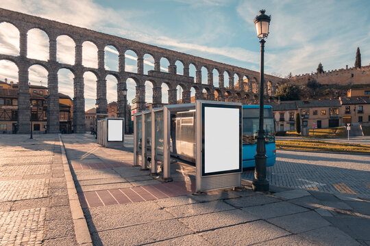 Ancient aqueduct with urban bus stop in Segovia