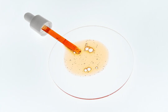 Vitamin C serum sample with pipette and bubbles