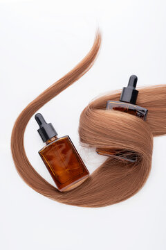 Hair serum with amber bottles and sleek strands