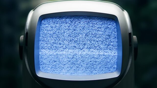 Retro TV, vintage television In a nostalgic setup, a retro TV displays grain on screen, scary halloween night device good for chroma key and green screen.