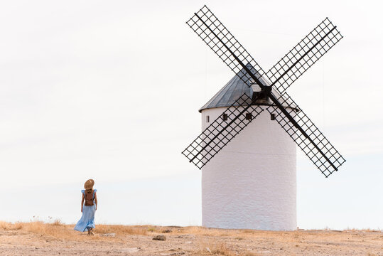 Woman exploring la mancha windmills in spain