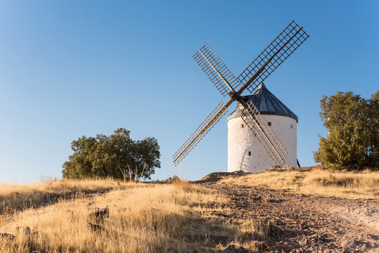 Traditional windmill in La Mancha at sunset