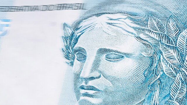 Background texture vignette of Brazilian money notes, 100 reais notes, background for video or backdrop. Concept of prize or payment, fortune.