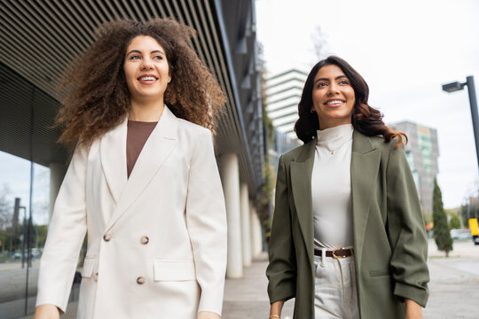 Professional women walking together outdoors
