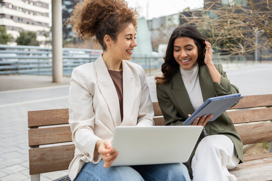 Women collaborating outdoors on business project