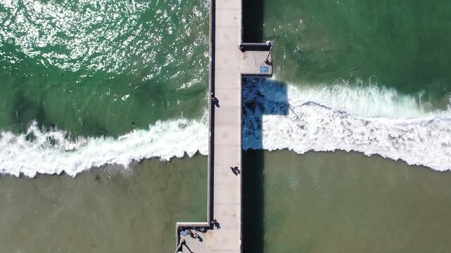 With its captivating aerial perspective, the view from above Venice Beach Pier showcases a stunning emerald waves under the Pier structure.