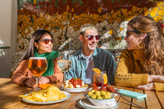 Friends socialising over tapas and drinks