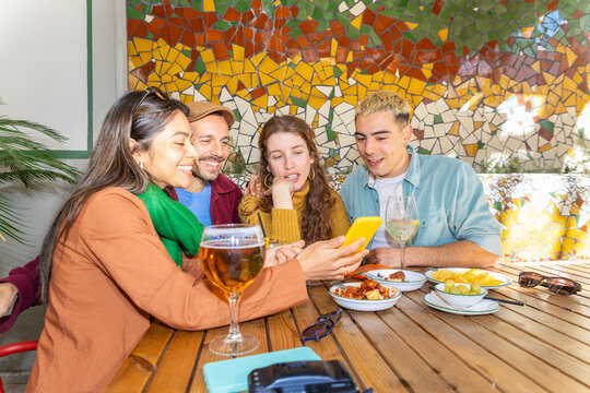 Friends enjoying quality time with tapas and drinks