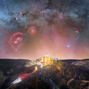 Astrophotography of Winter Milky Way with Orion and Pleiades Above Hoz de Alarcon and Castle