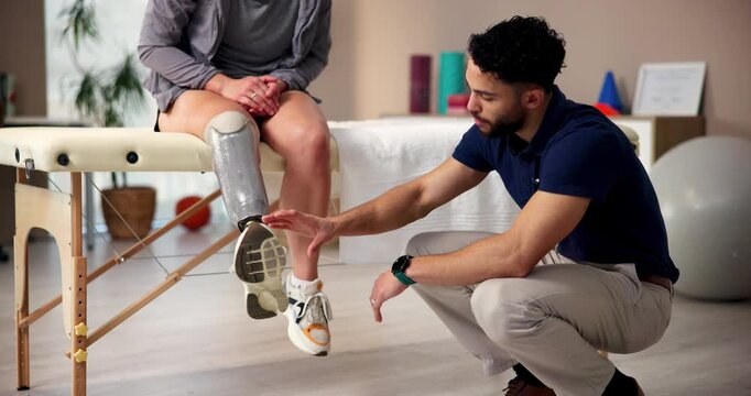 Consulting, leg or prosthetic with patient and physiotherapist in office for recovery or rehabilitation. Explain, healthcare or medical with amputee person and medicine professional in therapy clinic