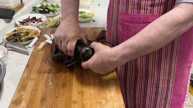 Preparing and cooking fresh lobster at home, with seafood arranged on a kitchen counter, capturing a hands-on home cooking process and authentic seafood preparation.