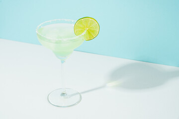 Margarita cocktail. Summer alcohol drink on blue background.