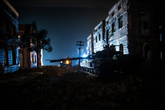 War Concept. Military silhouettes fighting scene on war fog sky background, World War Soldiers Silhouette Below Cloudy Skyline At night. Battle in ruined city.