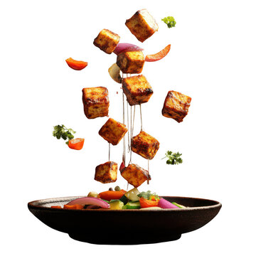 Tofu cubes and vegetables flying into a bowl of salad transparent background