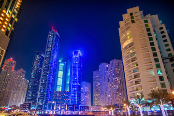 Fototapeta premium Night aerial view of Dubai Marina high-rise buildings and glowing waterfront