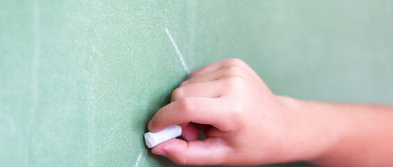 The child is writing on the blackboard © jovannig