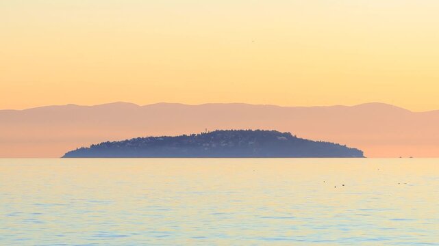 Sedef Island at sunset. Prince Islands in Istanbul, Turkey. Beautiful autumn colored sky over the Marmara Sea. Color graded in Dynamic range