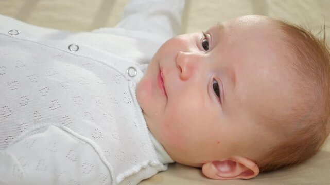 Infant Peacefully Exploring Mouth. Baby Lies On Blanket Gently Soothing With Finger Exploration. Calm Infant Peacefully Examines Mouth Reflexes While Dressed In Soft Clothing And Relaxing