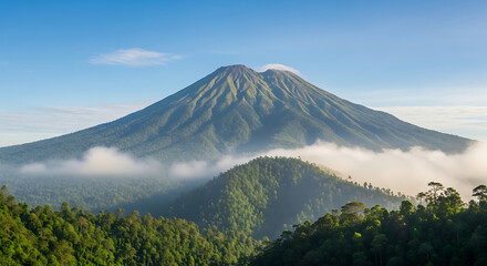 Obraz premium Majestic Volcano Peak Emerges from Lush Green Forests Above a Sea of Clouds