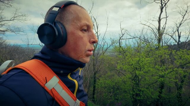 Mature man enjoying a quiet walk in the forest, escaping city stress to find balance in nature. Highlighting the importance of mental health and connecting with the environment.